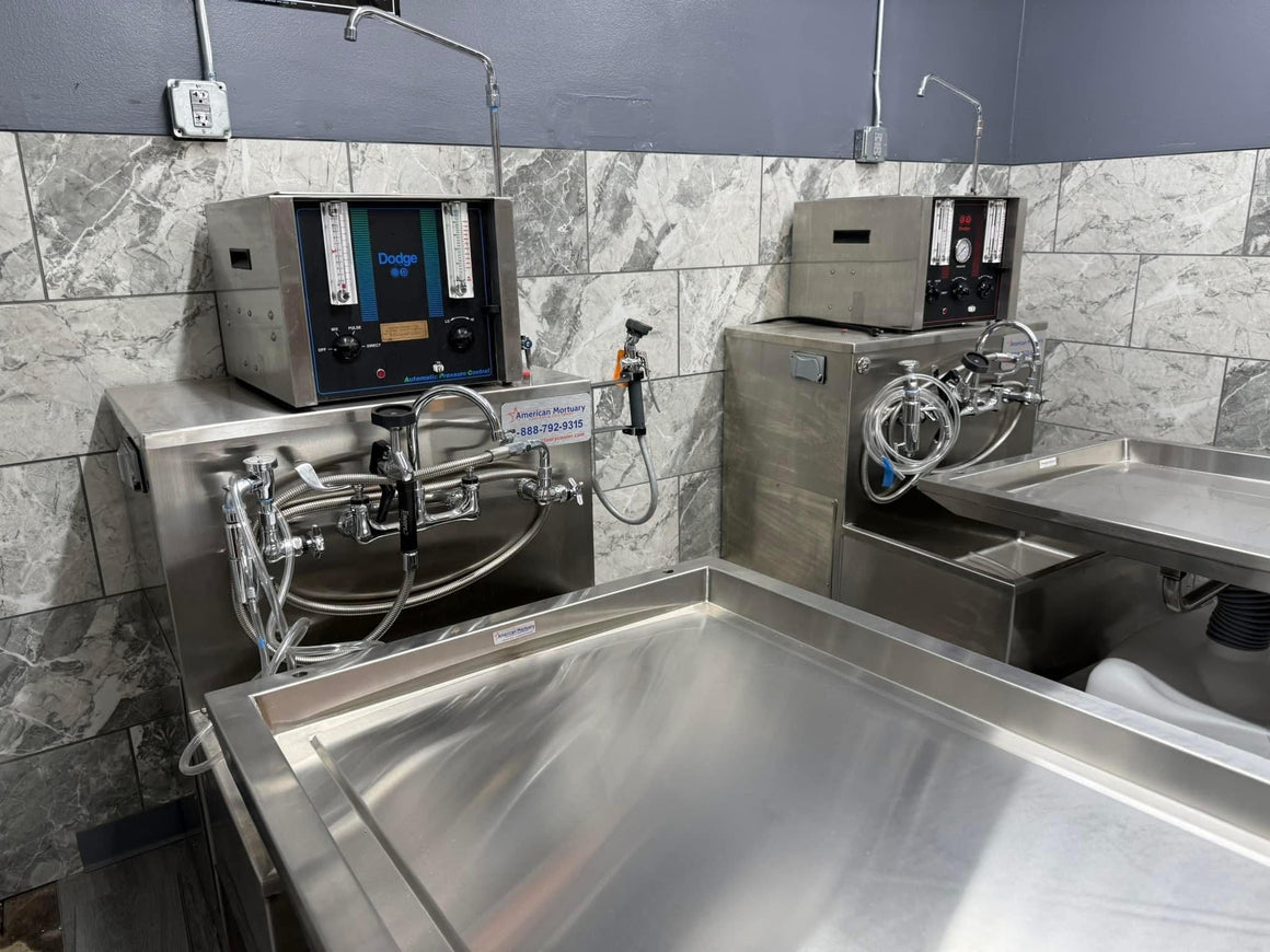 A side-by-side view of a hydraulic embalming table and a folded dressing table, emphasizing space-saving design