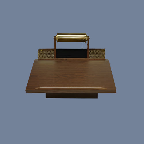 Elegant walnut funeral register desk with brass accents and lamp.